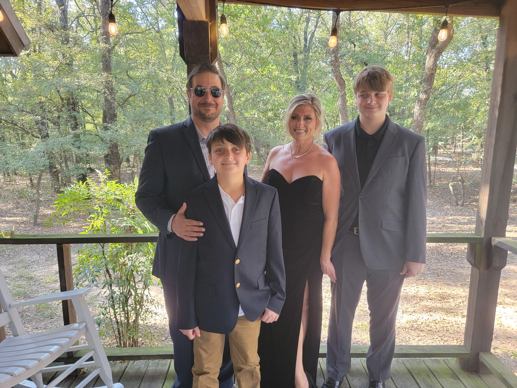 Greg Shosa with Nora and their two sons on a covered deck